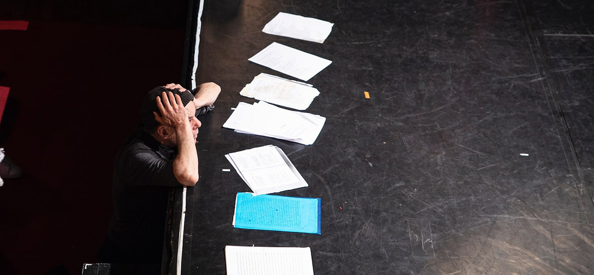 Un comédien et des textes de théâtre sur scène dans une école à Paris